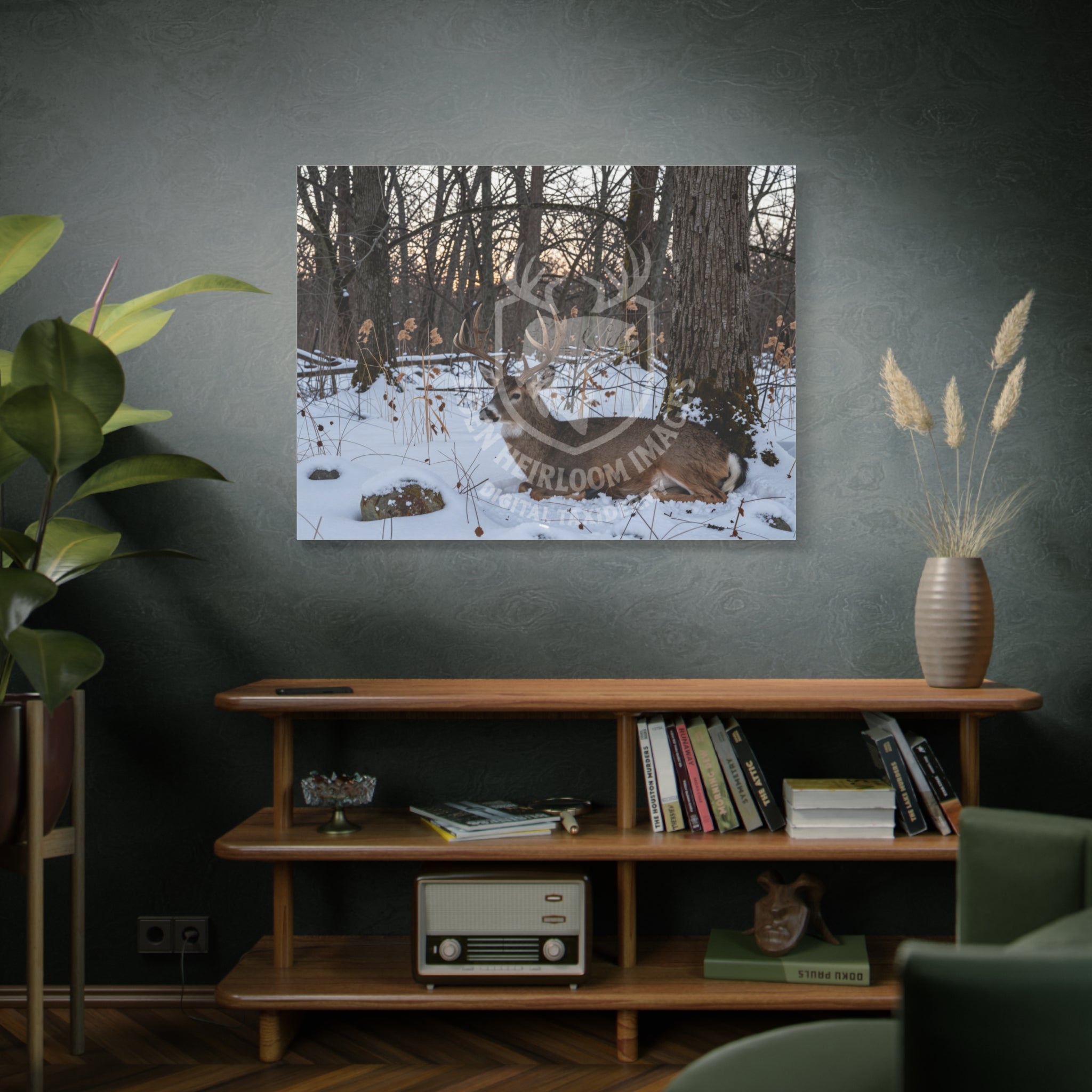 Display mockup of printed canvas hanging on wall of home, whitetail buck laying in snow beneath hardwood tree, ultra-realistic detail